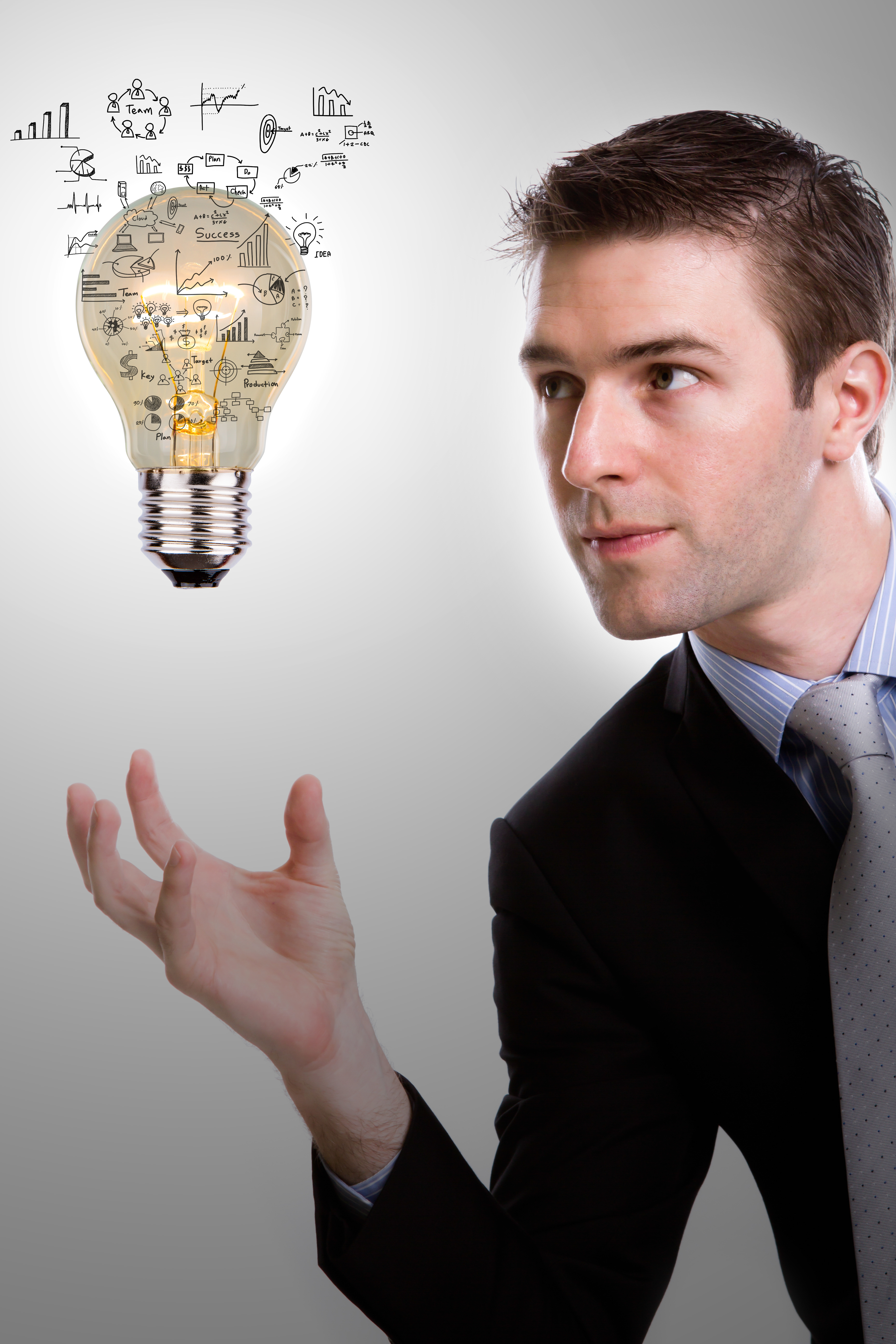 concentrated-businessman-looking-light-bulb-with-diagrams.jpg?1741195666803